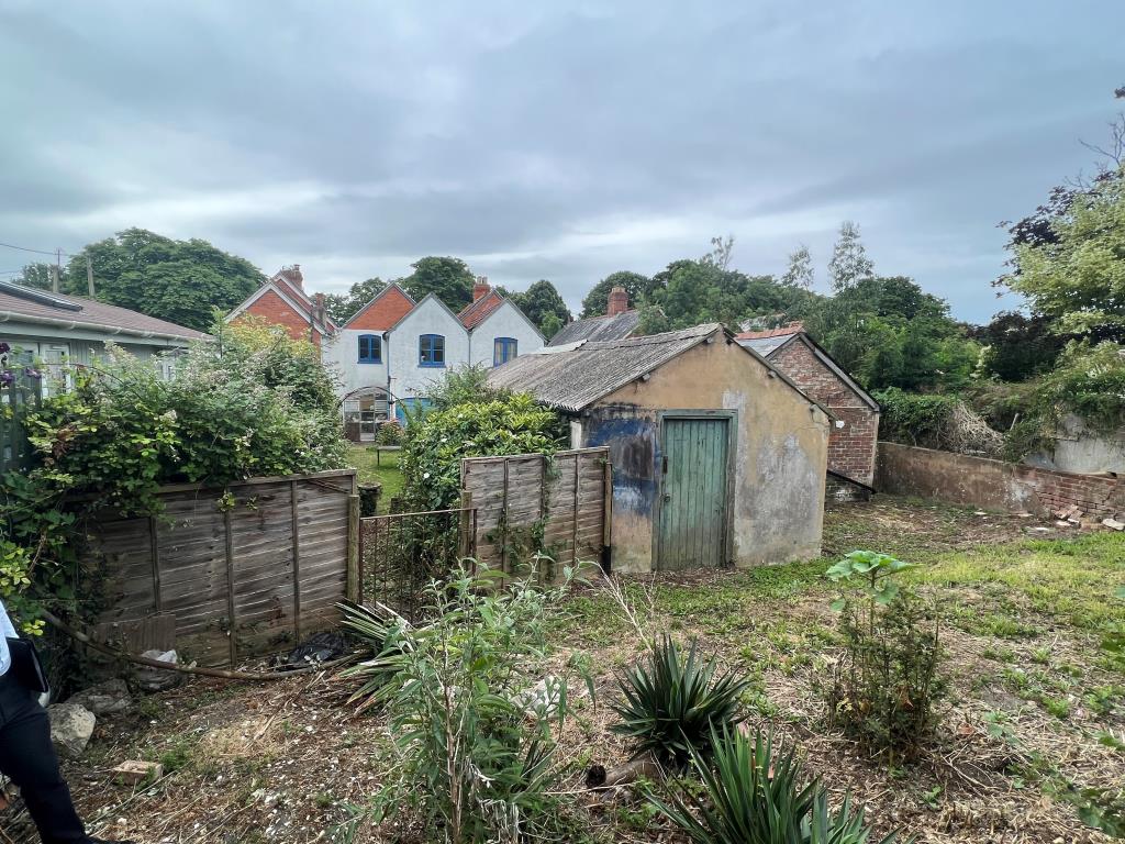 Lot: 76 - DOUBLE-FRONTED SHOP, FLAT LET TO A REGULATED TENANT AND FORMER BAKEHOUSE WITH POTENTIAL - Rear view of Freehold Investment Opportunity in Freshwater Isle of Wight